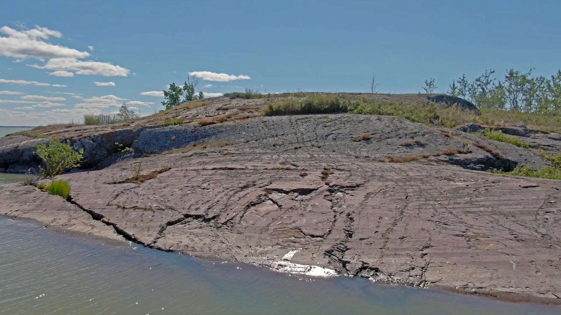 An aerial drone photography image of Footprint Rock, located on a small island in the center of Marian Lake.