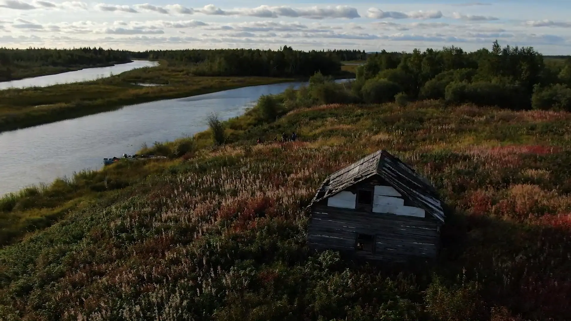 An overheard drone photography image of an old trading camp located near the shore of the Marian River.