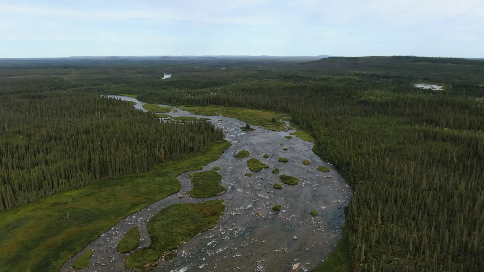 An overhead drone photography image of a campsite located on shore of the Marian River.